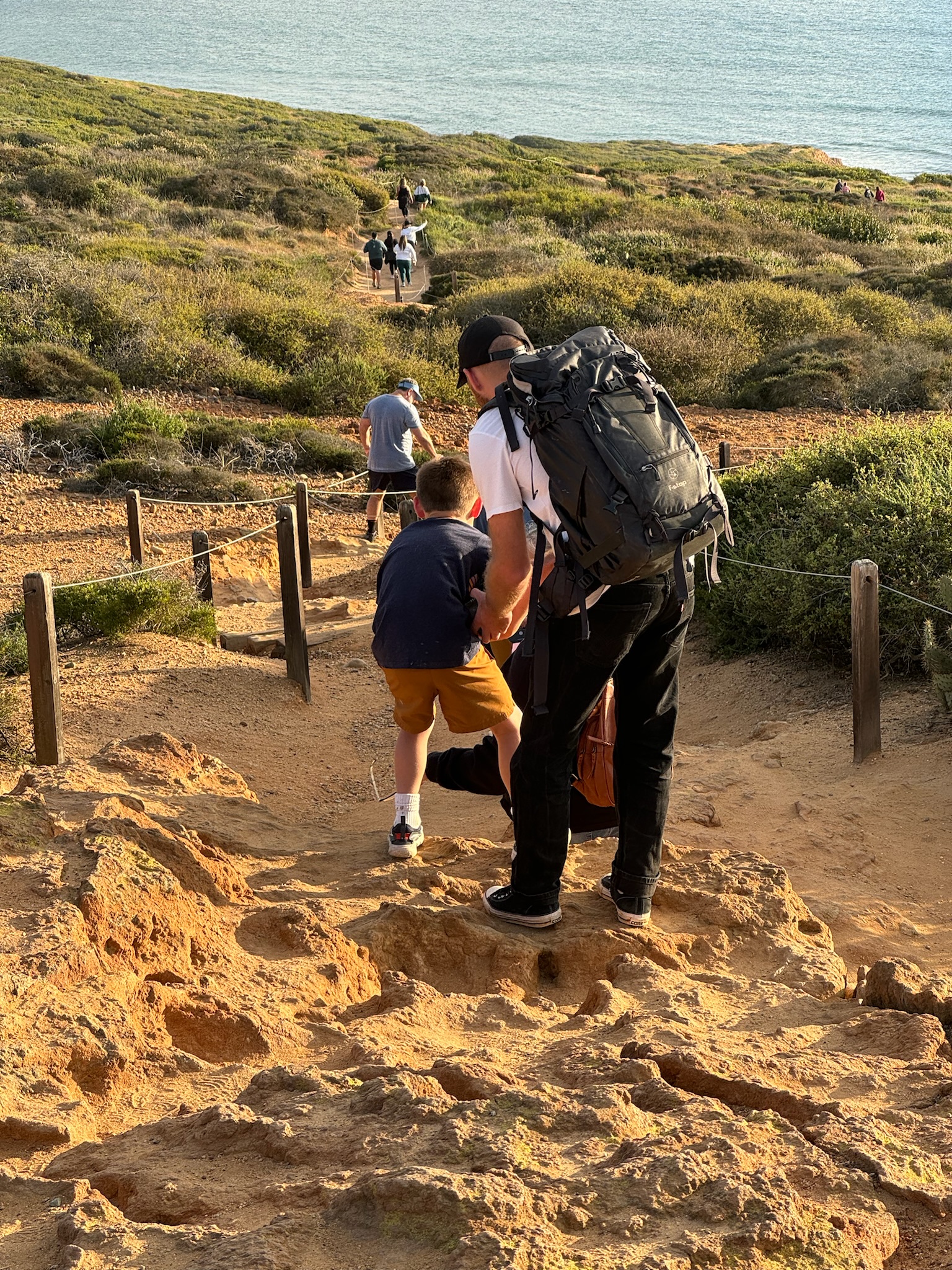 Crew filming on coastal cliffs